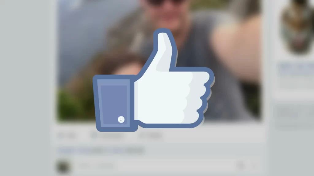 A Facebook Like thumbs up graphic over a blurred Facebook feed